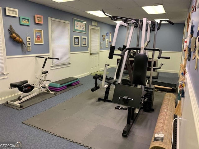 exercise room featuring a drop ceiling