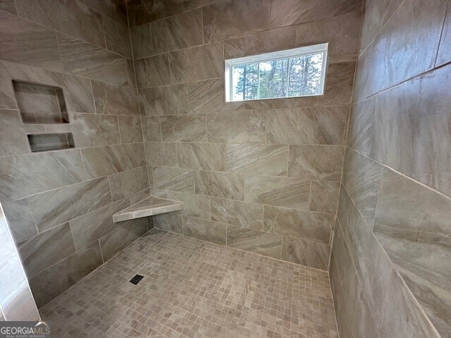 bathroom with tiled shower