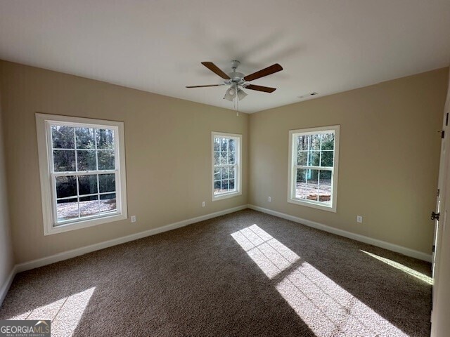 spare room with ceiling fan and carpet floors