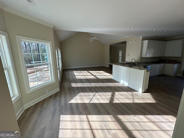 kitchen with light hardwood / wood-style flooring, sink, vaulted ceiling, and white cabinets