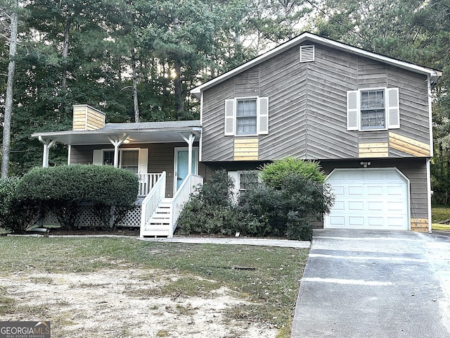 tri-level home with a garage and a porch