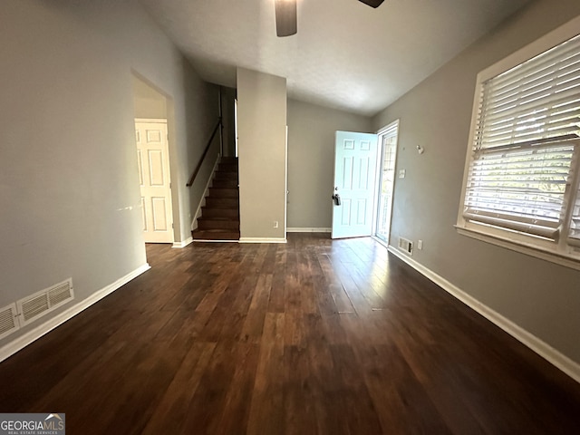 interior space with lofted ceiling, ceiling fan, and dark hardwood / wood-style floors