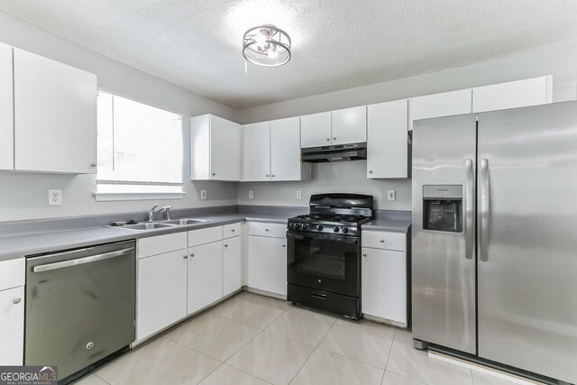 kitchen featuring a textured ceiling, stainless steel appliances, sink, white cabinets, and light tile patterned flooring