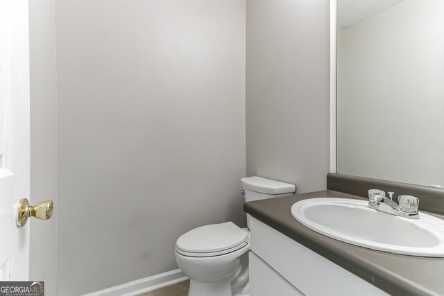 bathroom with toilet and vanity