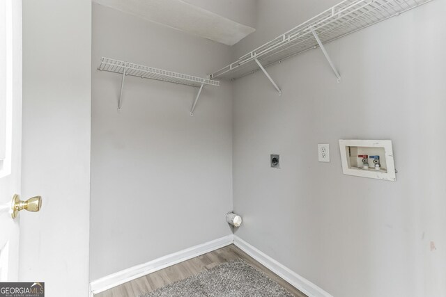 clothes washing area featuring washer hookup, hardwood / wood-style flooring, and hookup for an electric dryer