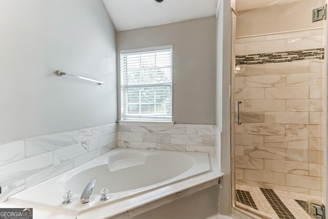 bathroom featuring independent shower and bath