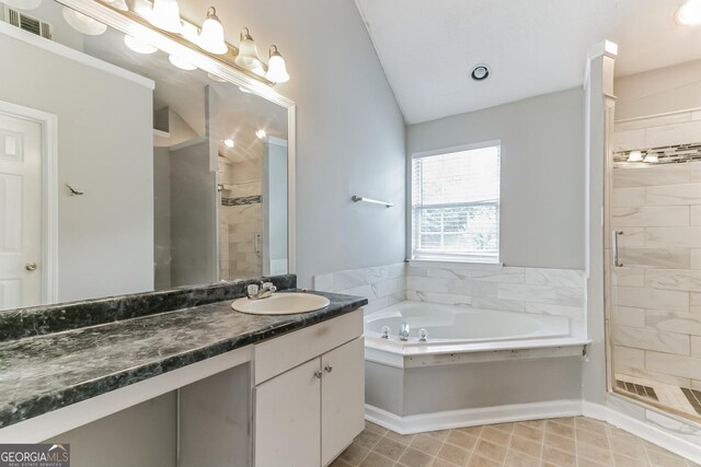 bathroom with lofted ceiling, vanity, and plus walk in shower