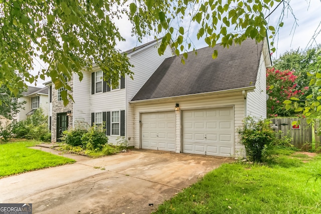 view of front of house featuring a front lawn and a garage