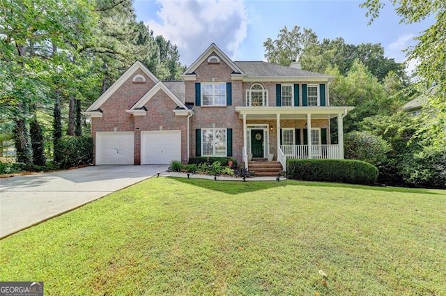 view of front of property featuring a garage, a front yard, and a porch