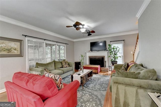 living room featuring plenty of natural light, ceiling fan, ornamental molding, and hardwood / wood-style flooring