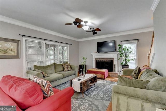 living room with a wealth of natural light, hardwood / wood-style flooring, and crown molding