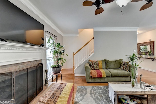 living room with ceiling fan, ornamental molding, and hardwood / wood-style floors