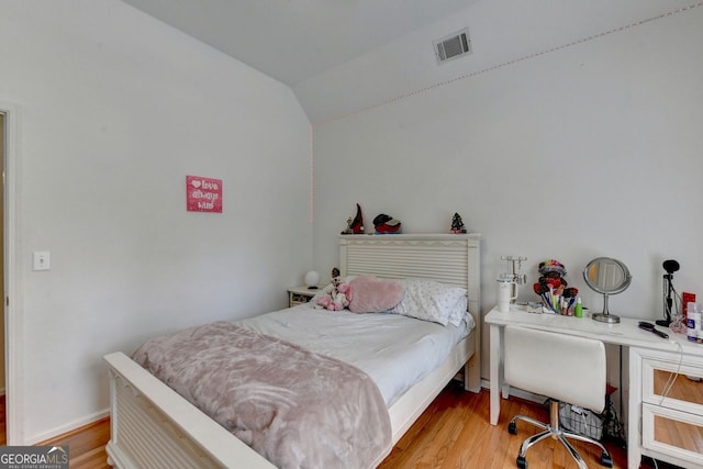 bedroom featuring vaulted ceiling and light hardwood / wood-style floors