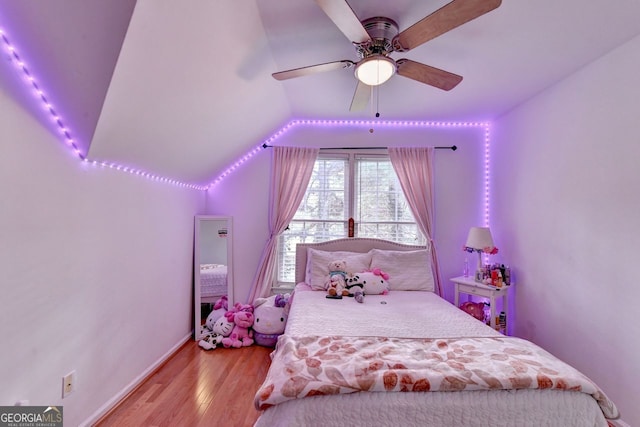 bedroom with light wood-type flooring, ceiling fan, and vaulted ceiling