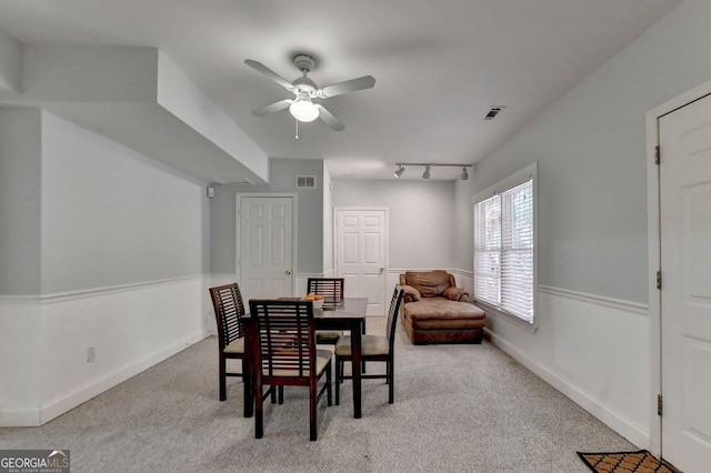 dining area with light colored carpet, ceiling fan, and rail lighting