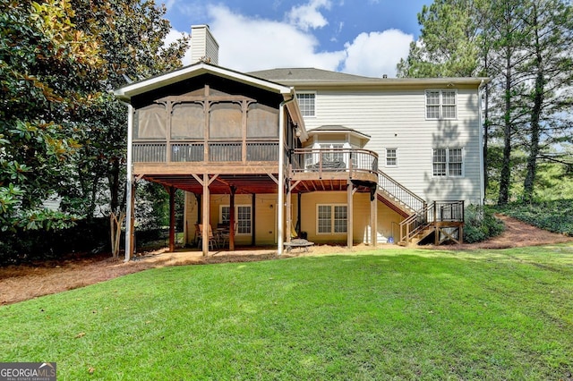 rear view of property featuring a yard and a wooden deck