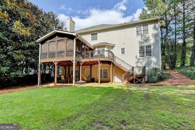 back of house featuring a wooden deck, a yard, and a sunroom