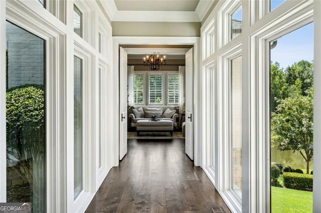 hallway featuring dark wood-type flooring and a notable chandelier