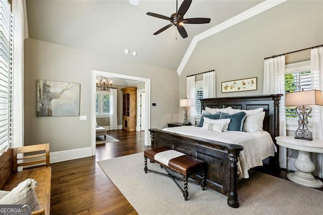 bedroom featuring lofted ceiling, crown molding, dark hardwood / wood-style floors, and ceiling fan with notable chandelier