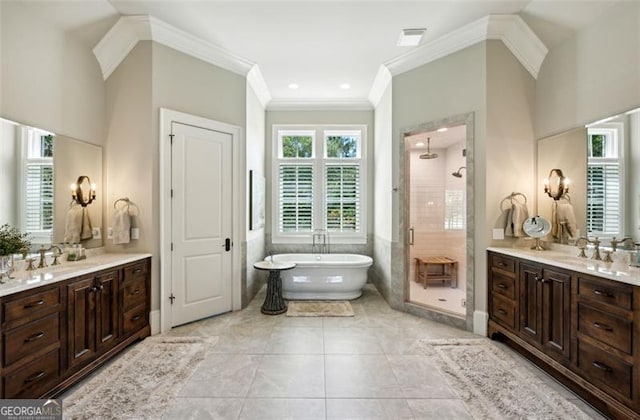 bathroom with crown molding, vanity, separate shower and tub, and tile patterned floors