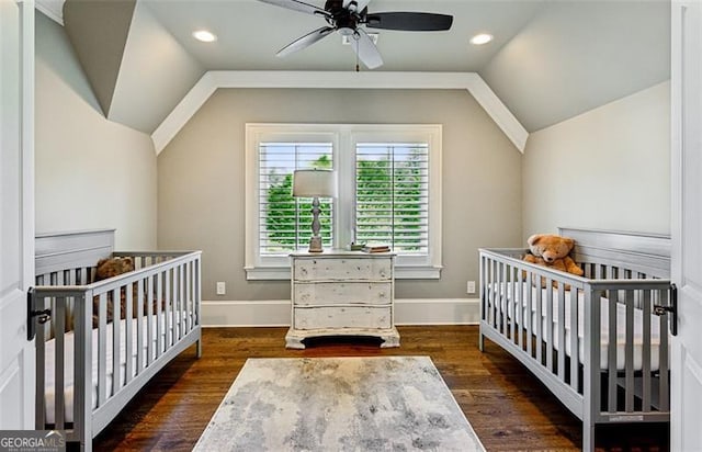 bedroom featuring a crib, ceiling fan, and dark hardwood / wood-style floors