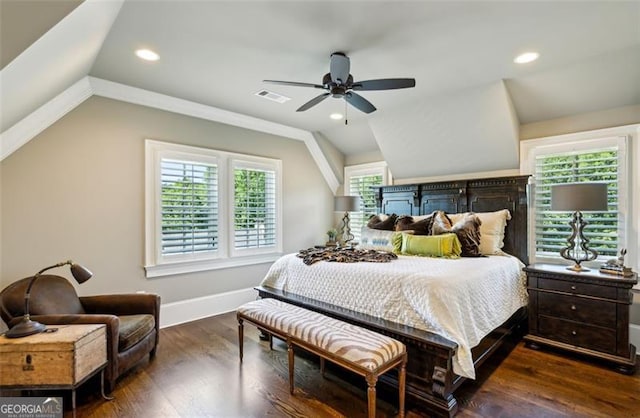 bedroom with dark wood-type flooring, vaulted ceiling, and ceiling fan