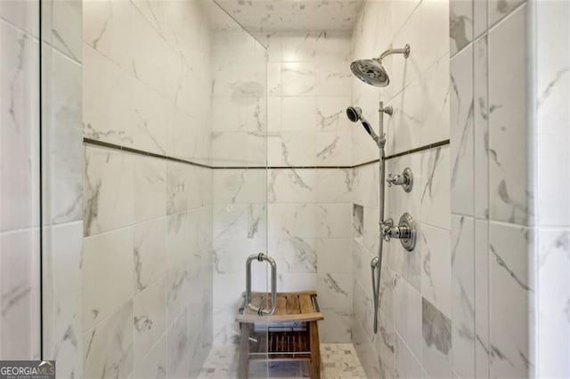 bathroom featuring a shower with shower door