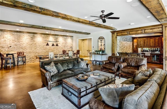 living room featuring brick wall, beam ceiling, and ceiling fan