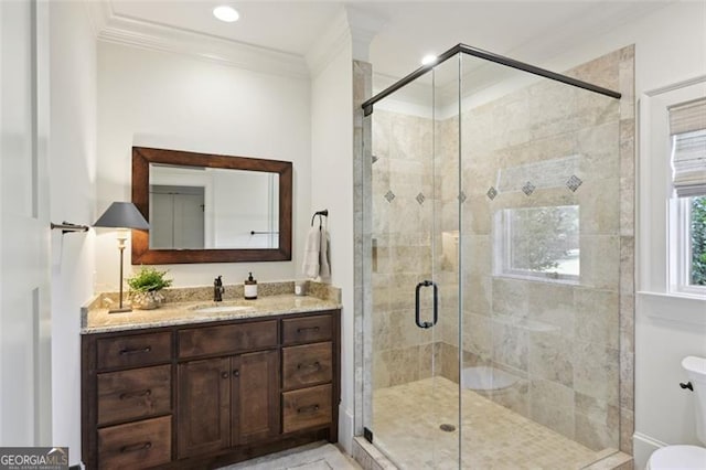 bathroom with toilet, a shower with door, crown molding, and vanity