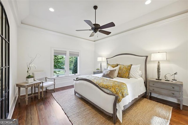 bedroom with dark wood-type flooring, ceiling fan, and ornamental molding