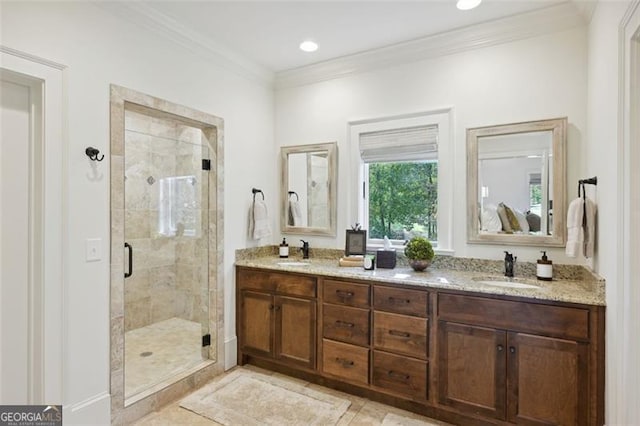 bathroom with crown molding, vanity, and a shower with shower door