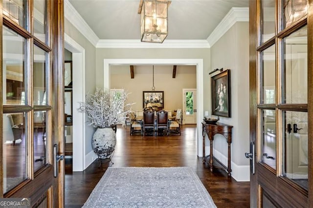 entryway featuring ornamental molding, dark hardwood / wood-style flooring, and a notable chandelier