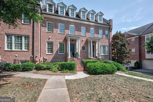 georgian-style home featuring brick siding