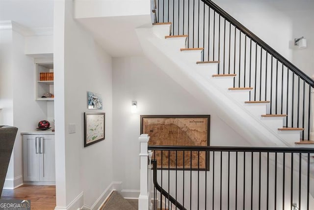 stairway featuring wood-type flooring