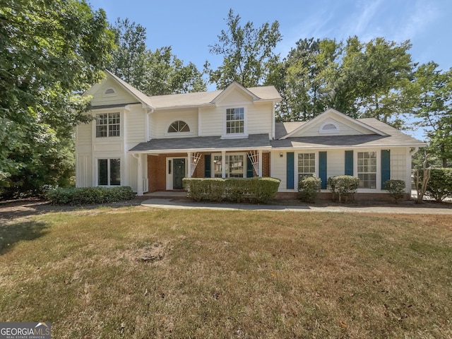 traditional-style house with brick siding and a front yard