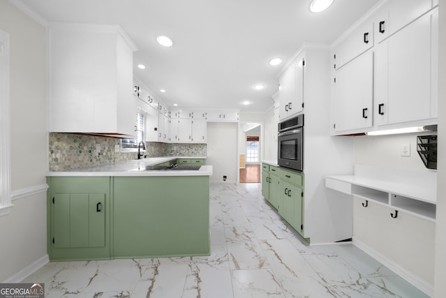 kitchen with green cabinets, white cabinets, oven, crown molding, and decorative backsplash