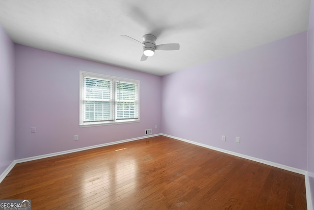 spare room featuring ceiling fan and dark hardwood / wood-style flooring