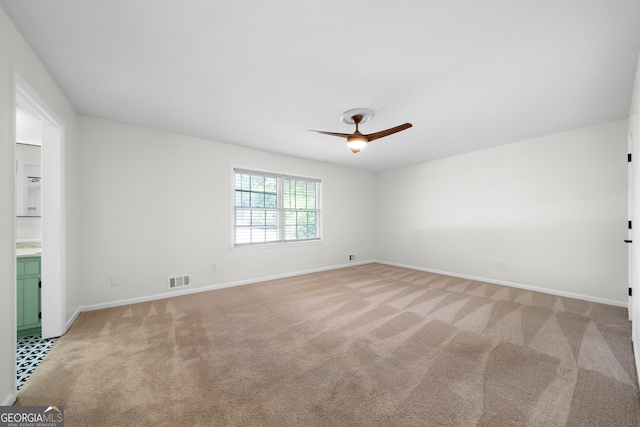 carpeted empty room with ceiling fan