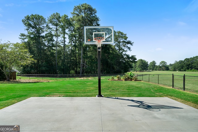 view of basketball court featuring a yard