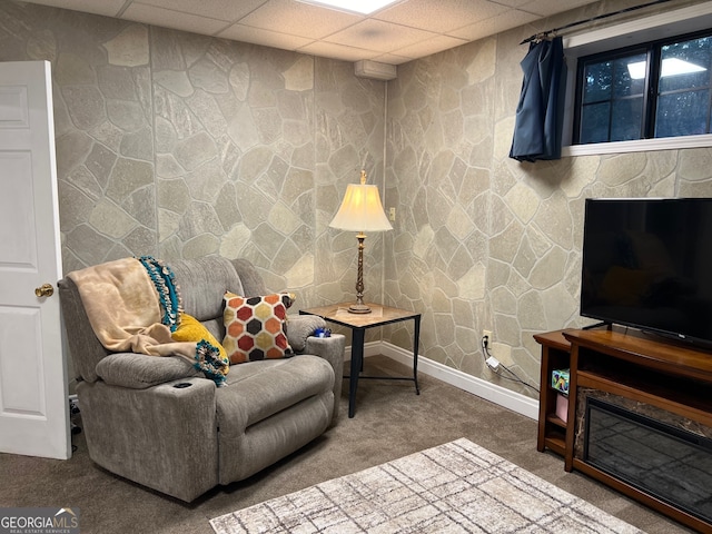 sitting room with a drop ceiling and carpet floors