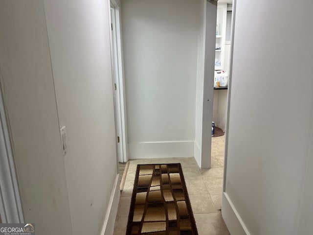 hallway featuring light tile patterned flooring