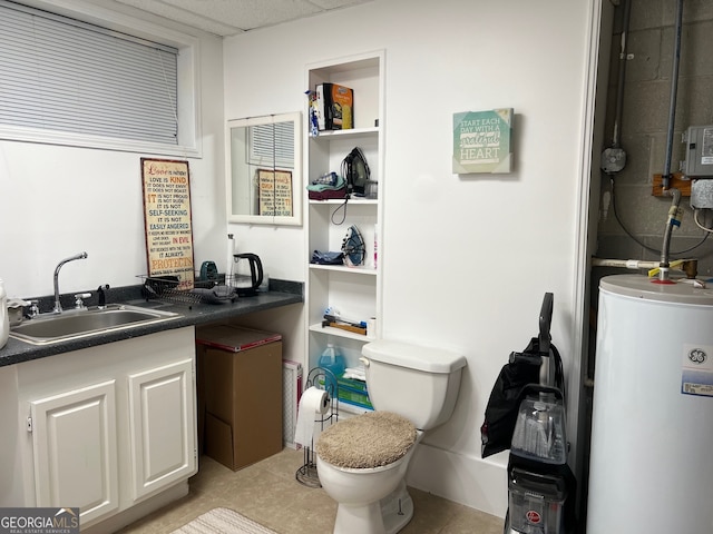 bathroom with tile patterned flooring, vanity, toilet, and water heater