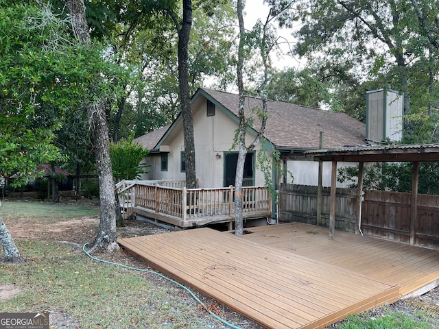 back of property featuring a deck