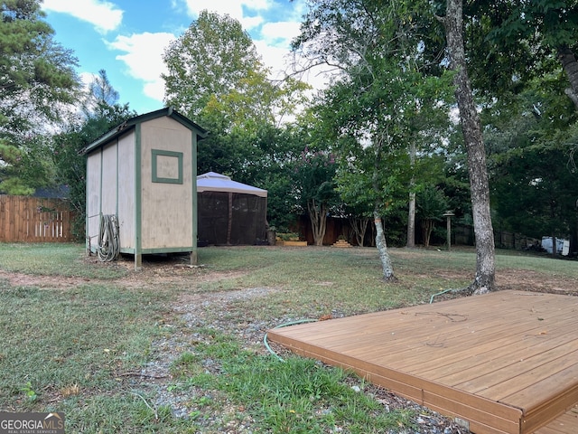 view of yard with a wooden deck and a shed