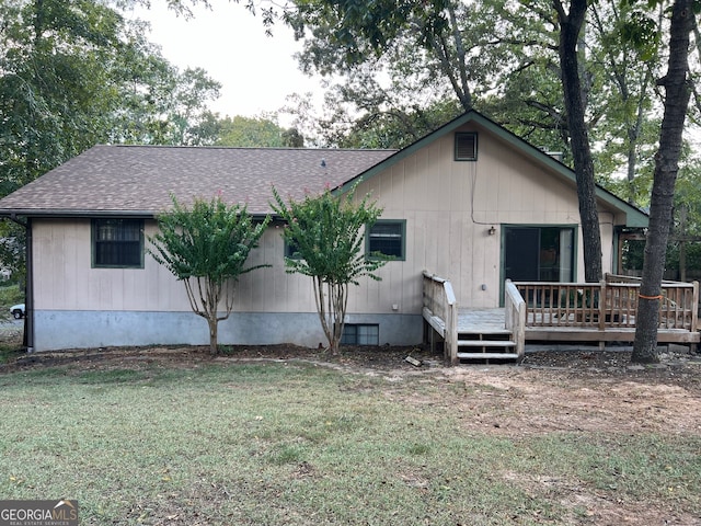 back of property with a yard and a deck