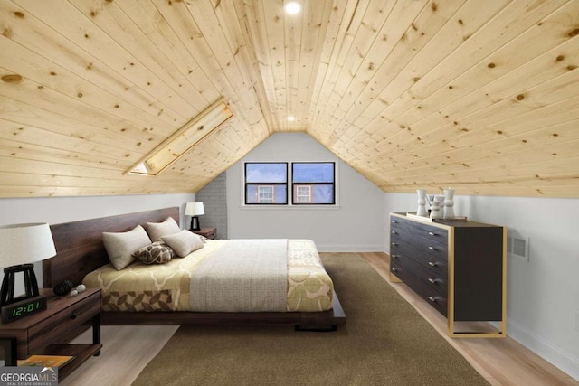 bedroom featuring wooden ceiling, vaulted ceiling with skylight, and hardwood / wood-style floors