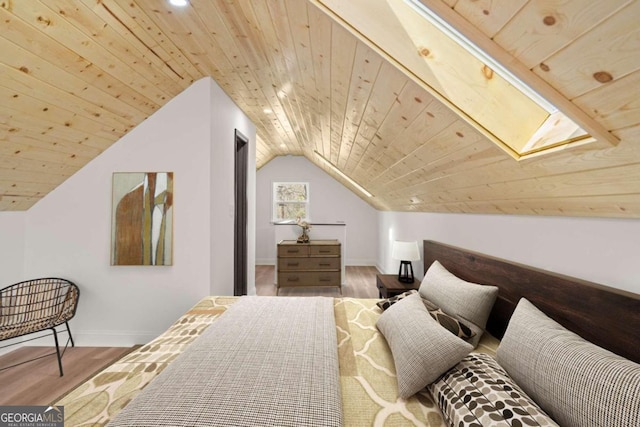 bedroom featuring wood ceiling, hardwood / wood-style floors, and lofted ceiling with skylight