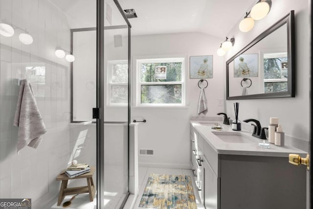 bathroom with lofted ceiling, tile patterned floors, an enclosed shower, and vanity