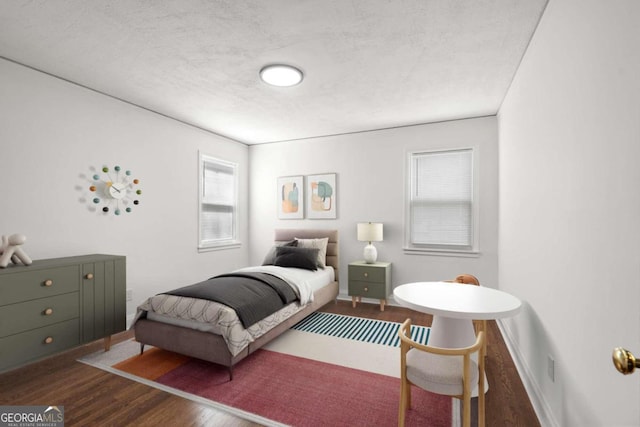 bedroom featuring hardwood / wood-style floors and a textured ceiling