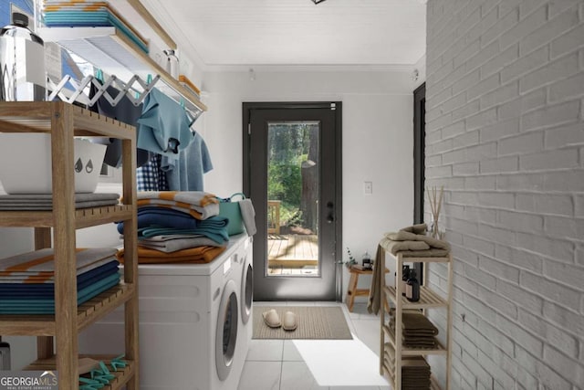 washroom featuring crown molding, a healthy amount of sunlight, brick wall, and separate washer and dryer